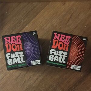 2 NeeDoh Fuzz Ball Velvet Squeezes - Purple & Orange